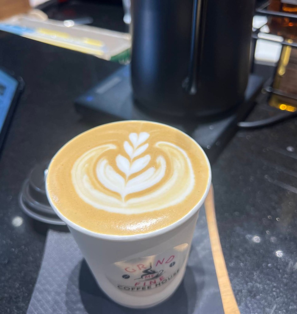 Flat lay of latte with gold spoon