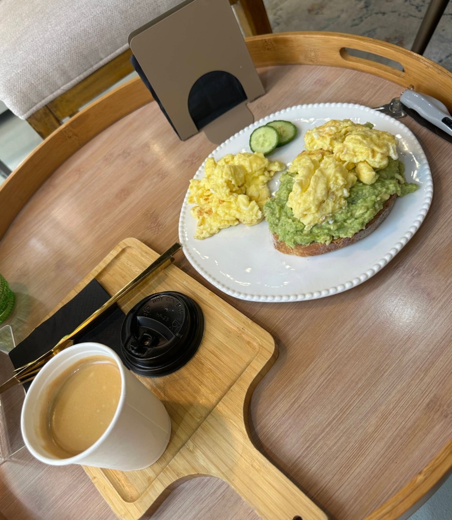 Avocado toast with scrambled eggs and coffee