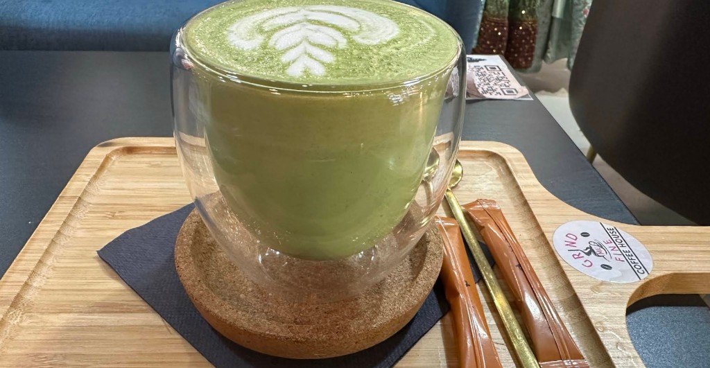 Matcha latte with art in double-wall glass