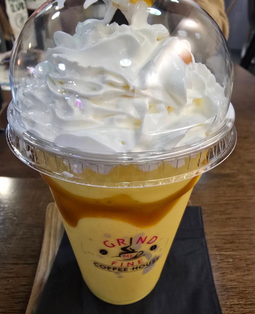 Iced caramel frappe with whipped cream dome